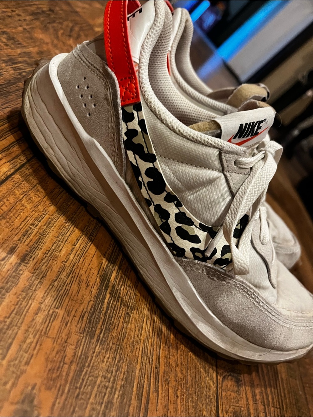 Nike Women’s White Sneakers with Orange Trim and Black Leopard Swoosh